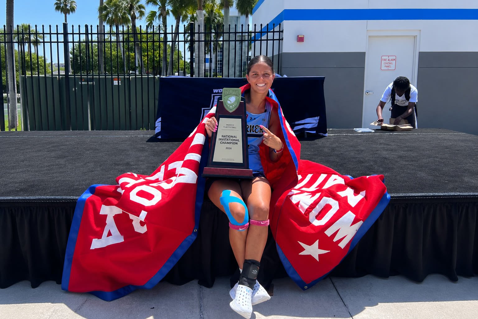 Kayleigh Thomas holding the 2026 National Invitational Champion trophy